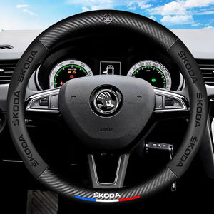 Steering wheel with Skoda logo on a car dashboard