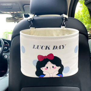Car organizer with cartoon design and 'LUCK DAY' text on a car seat.