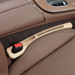 Close-up of a car's brown interior with a handbrake and gear shift.