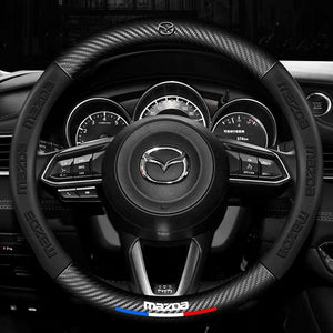 Steering wheel with Mazda logo in a car interior