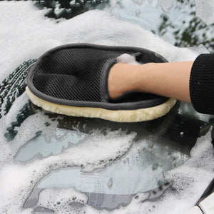 Person cleaning a car window with a soapy sponge