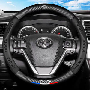 Steering wheel and dashboard of a Toyota vehicle with visible Toyota logo.