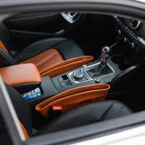 Close-up of a car's interior with brown leather accents and a gear shift.