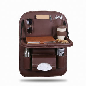 Brown leather car organizer with various items on a white background