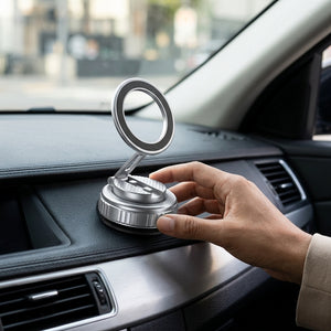 Hand placing a silver car phone holder on a car dashboard.