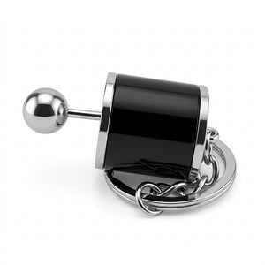 Metallic door handle with black cylindrical component on a white background