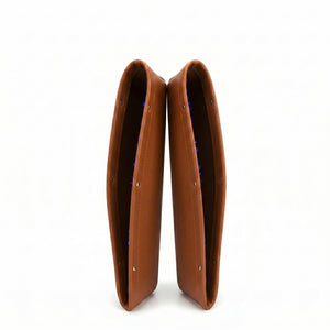 Pair of brown leather boot covers on a white background