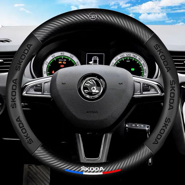 Steering wheel with Skoda logo on a car dashboard
