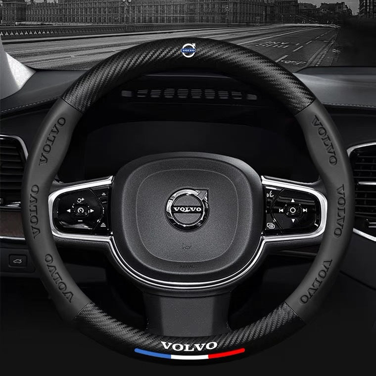 Steering wheel with Volvo logo and branding inside a car.