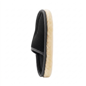 Black and beige grooming brush on a white background