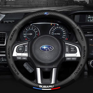 Steering wheel with Subaru logo in a car interior