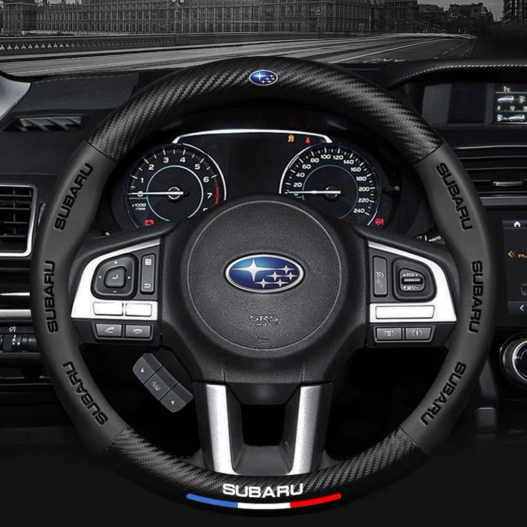 Steering wheel with Subaru logo in a car interior