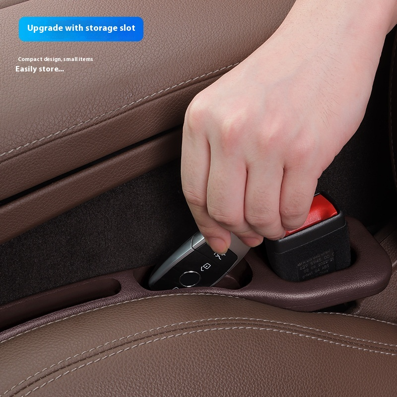 Hand inserting a small item into a car seat storage compartment.