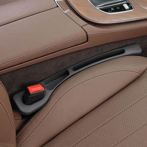 Close-up of a car's brown interior with a seat and door handle.