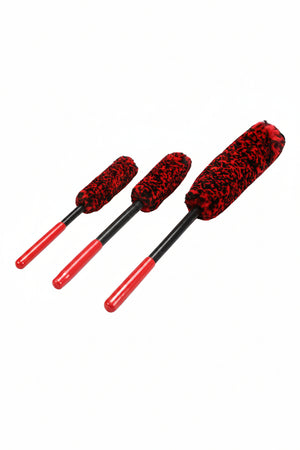 Three red and black car cleaning brushes on a white background