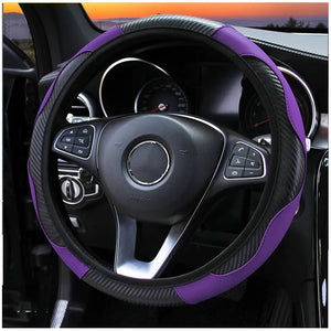 Steering wheel cover with purple and black design on a car steering wheel