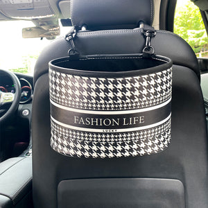 Black and white patterned car organizer hanging from a car seat.