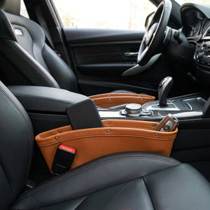 Car interior with a brown leather cup holder and smartphone stand.