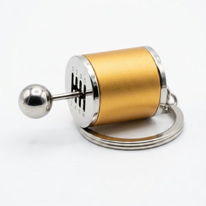 Gold and silver cylindrical keychain on a white background