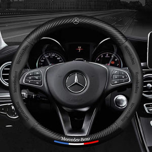 Steering wheel of a Mercedes-Benz car with logo and branding.