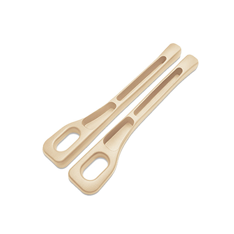Two beige wooden tongs on a white background
