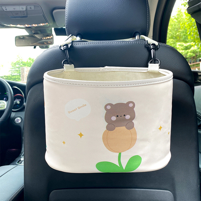 Car organizer with bear design attached to a car seat