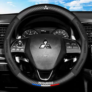 Steering wheel of a Mitsubishi car with visible logo and branding.